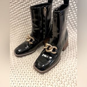 Steve Madden Lorreen ankle bootie. Black patent leather with chain detailing.